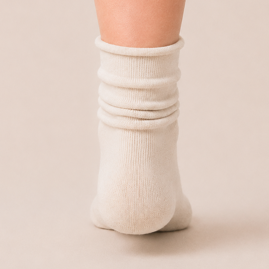 Cream slouch sock worn scrunched down, back view